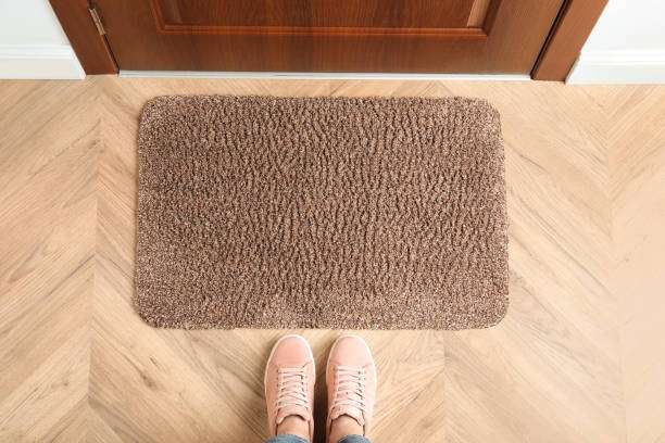 Woman standing near bath mat