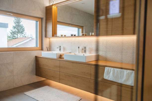 A modern bathroom with two sinks and a big mirror bath mat