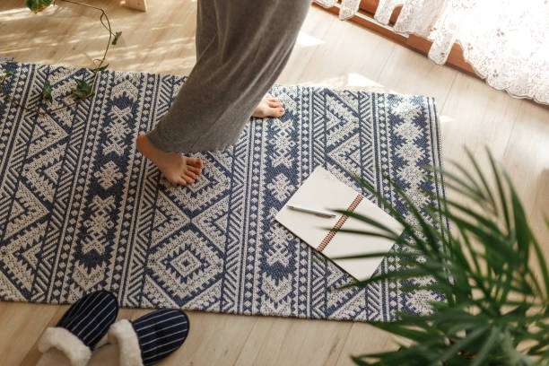 a man's feet on a brown bath mat