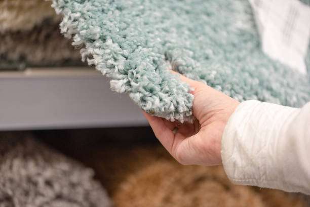 Woman choosing a new bath mat for home.