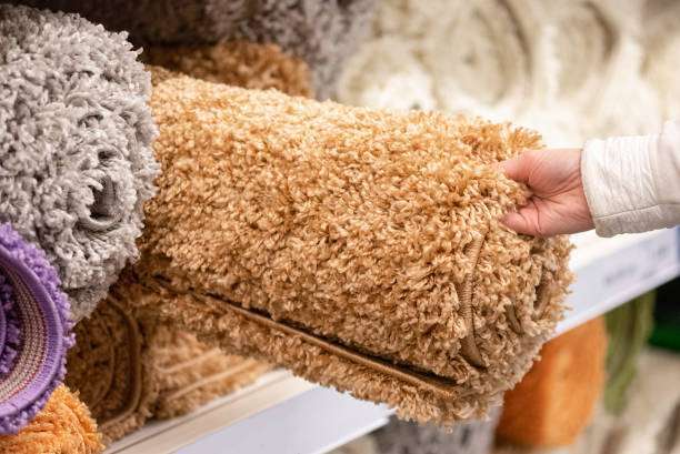 Woman choosing a new bath mat for home.