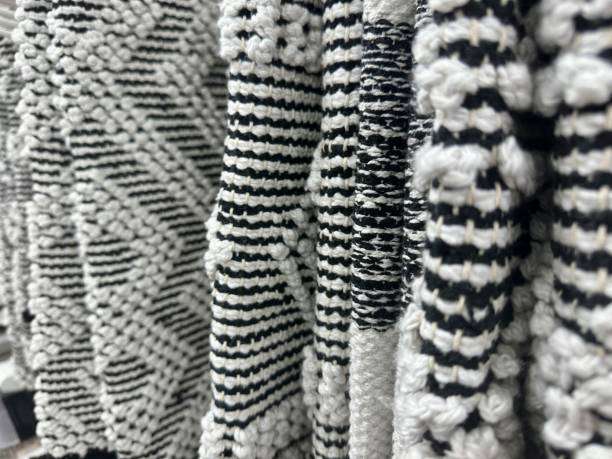 A close-up of various textured black and white bath mat designs, showing patterns.