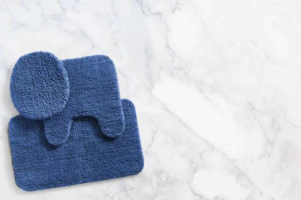 Blue bathroom bath mat set on a marble background