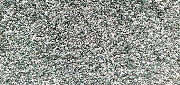 Texture shot of a soft, fuzzy green-grey material, excellent for a comfortable bath mat.
