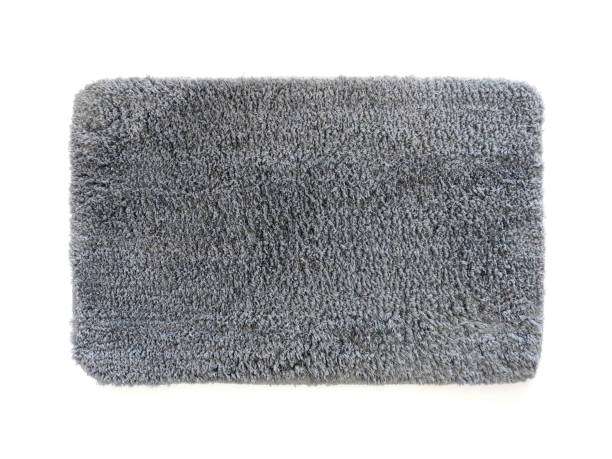 Aerial view of a microfiber bath mat with gray hair.