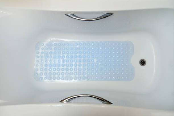 Clear blue textured bath mat inside a white bathtub.