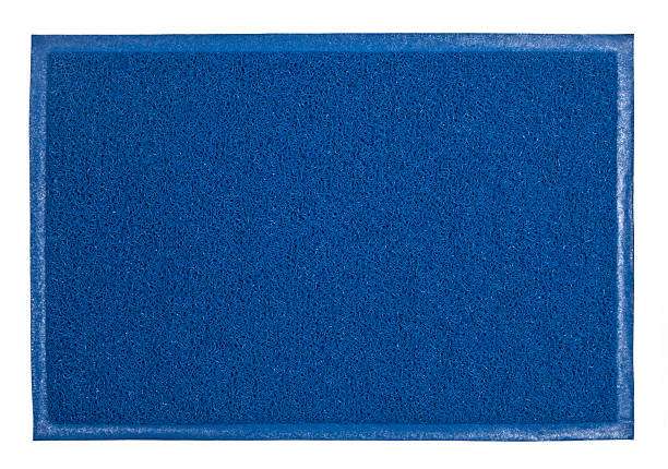 Blue textured bath mat with white border.