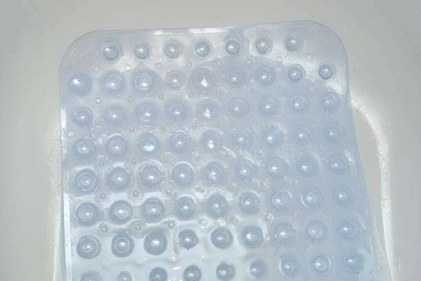 Clear shower bath mat with suction cups for safety.