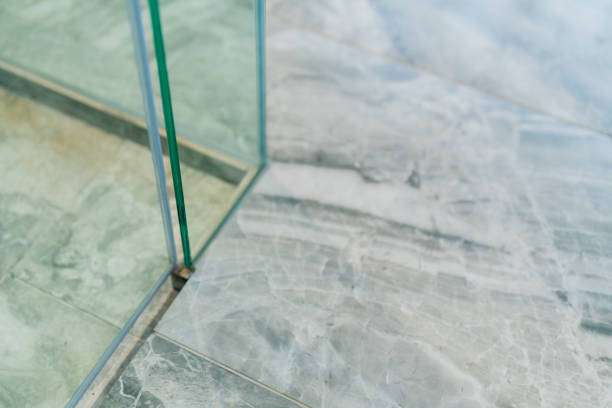 Modern grey marble bathroom floor and glass partition, perfect for a non-slip bath mat.